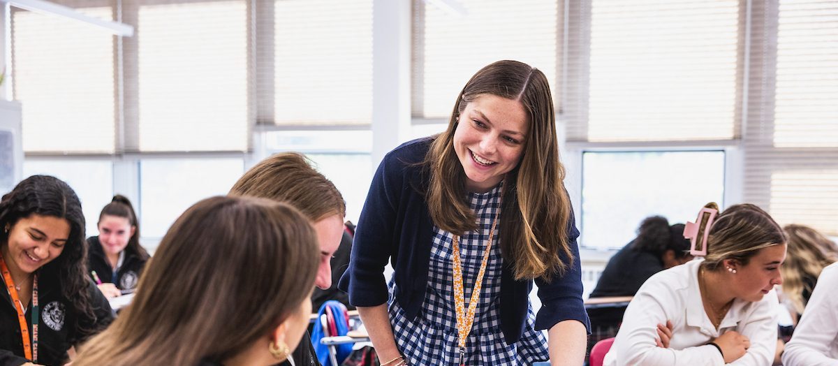 teacher helping students in class